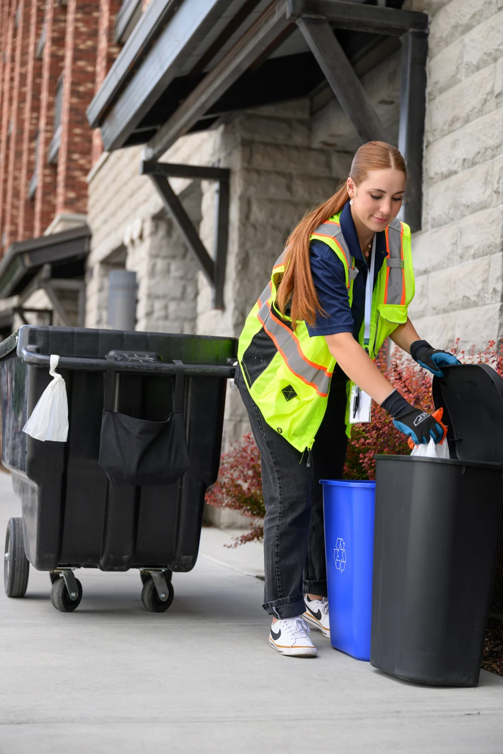 A WSI associate collecting a securely tied bag from a resident’s bin